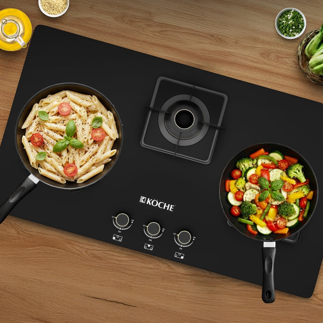 Köche induction cooktop with two pans cooking pasta and vegetables in modern kitchen