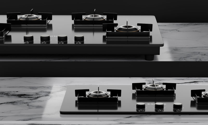 Close-up of 3-burner gas stove hob on marble kitchen countertop