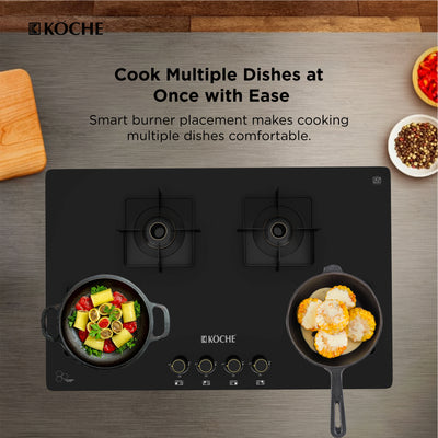 Köche black 2-burner gas cooktop with four control knobs on a wood-grain countertop