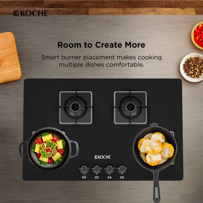 Köche black glass gas hob with 4 smartly spaced burners, shown with food cooking