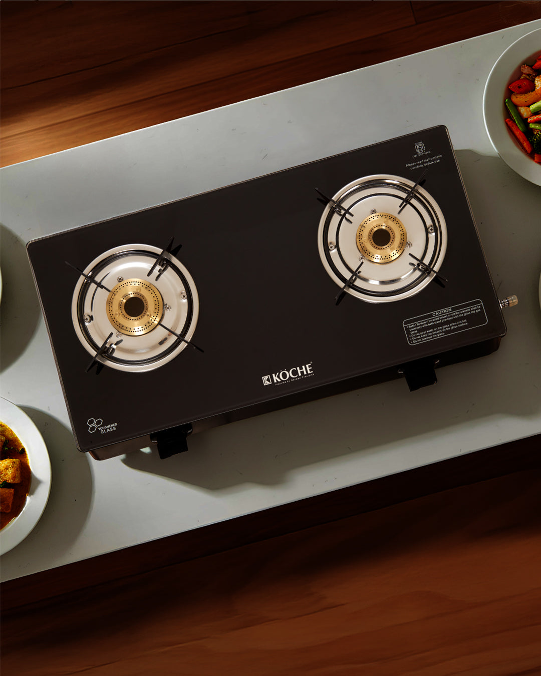 Köche 2 burner glass cooktop on a wooden kitchen counter.