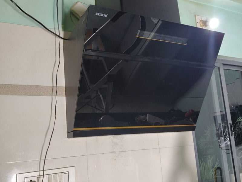   Laura 90cm Ducted BLDC Chimney | 1650 CMH Suction | Auto Clean A black glossy Koche Laura range hood mounted on a tiled kitchen wall 