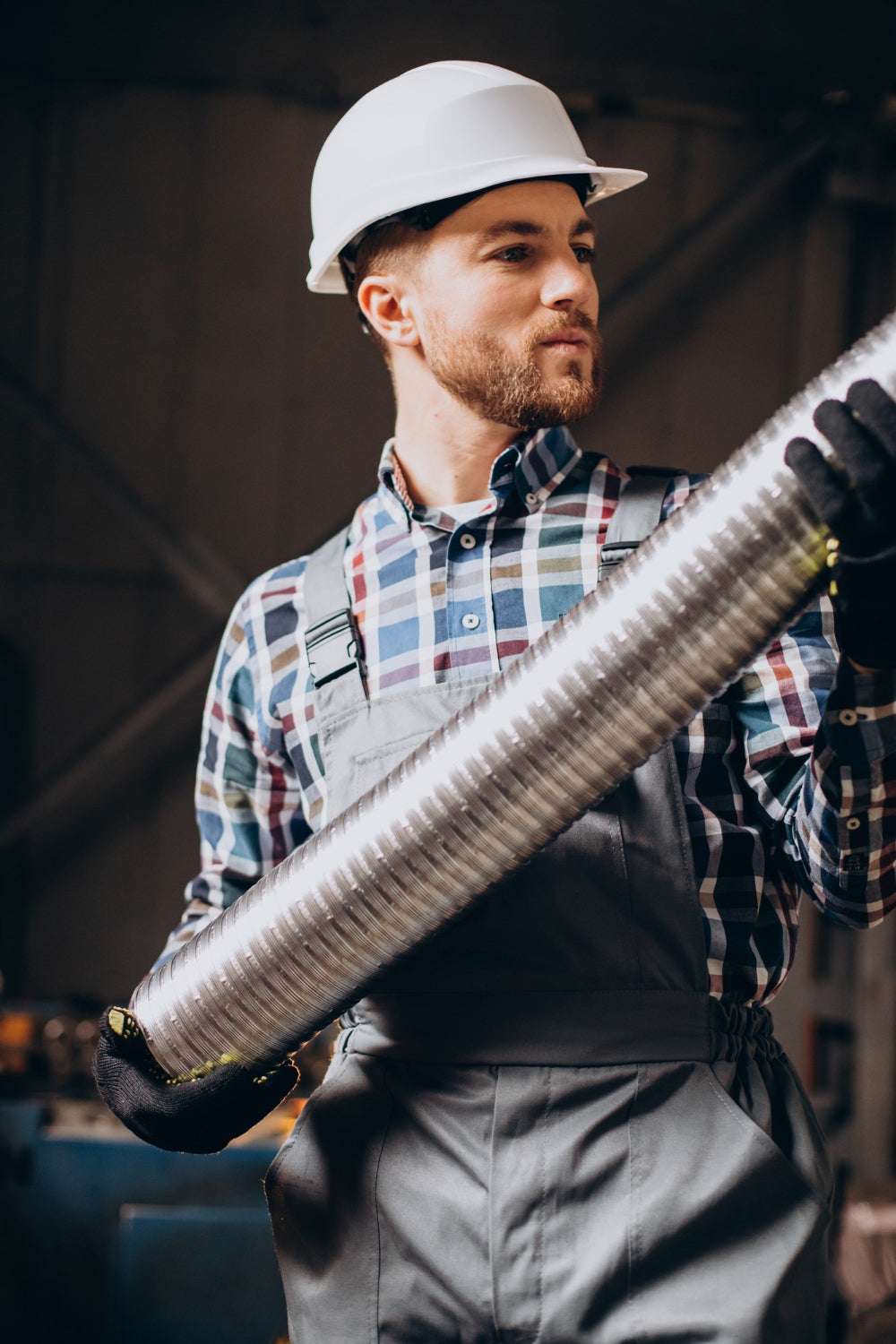 Köche workman assembling a chimney at the manufacturing unit.